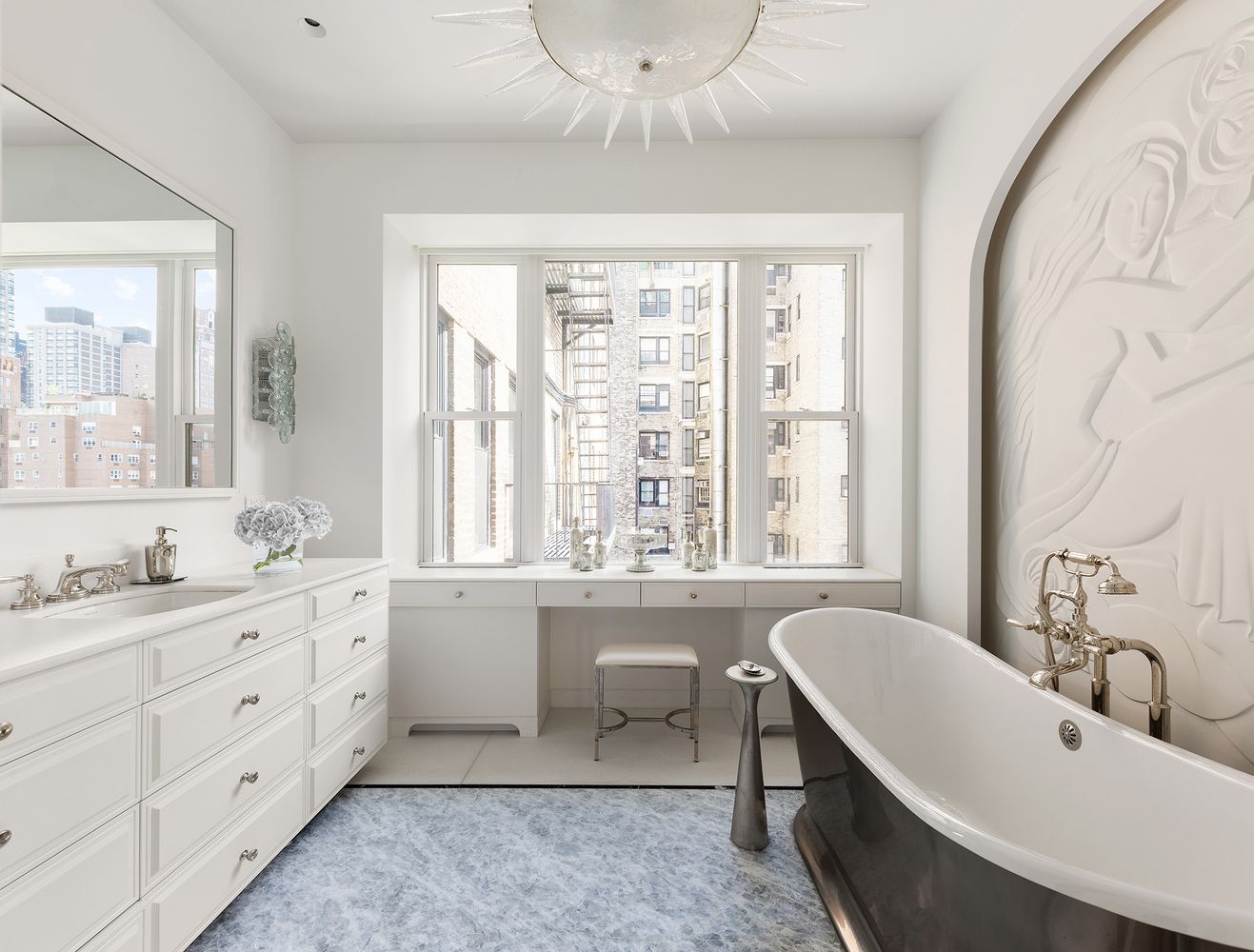 a bathroom with a granite countertop sink mirror and a bathtub