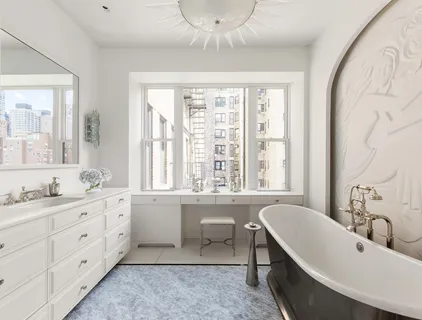 a bathroom with a granite countertop sink mirror and a bathtub