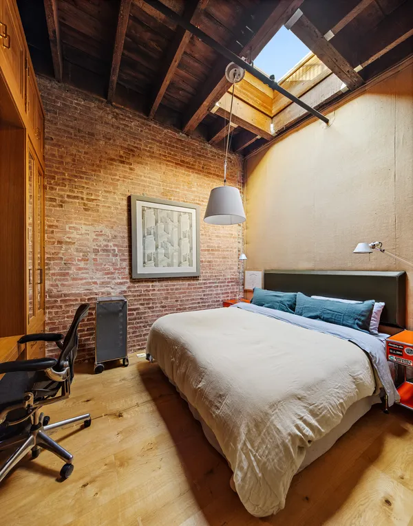 a bedroom with a bed and a desk