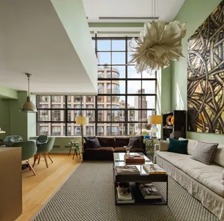 a living room with furniture a rug and a chandelier