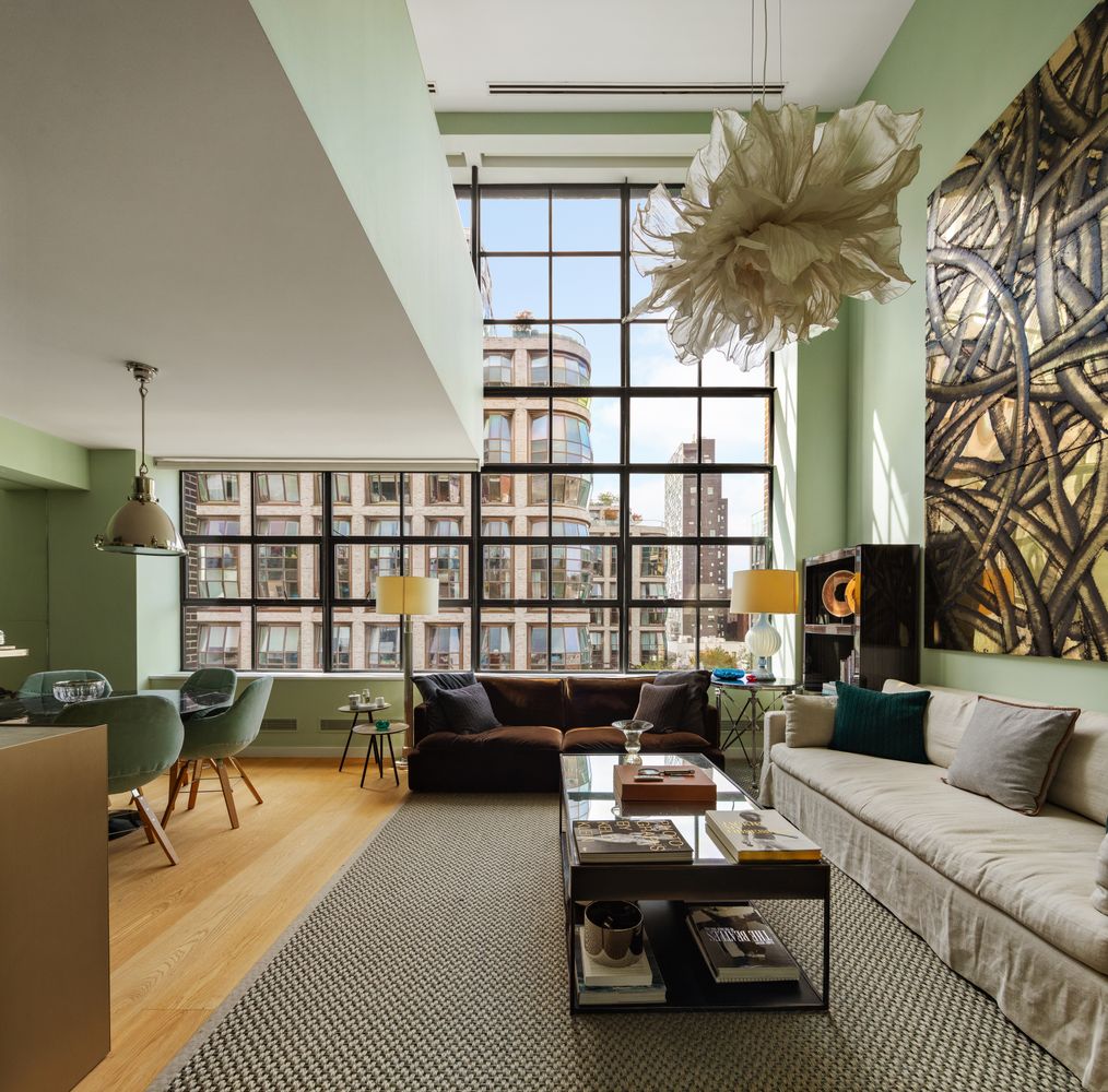 a living room with furniture a rug and a chandelier