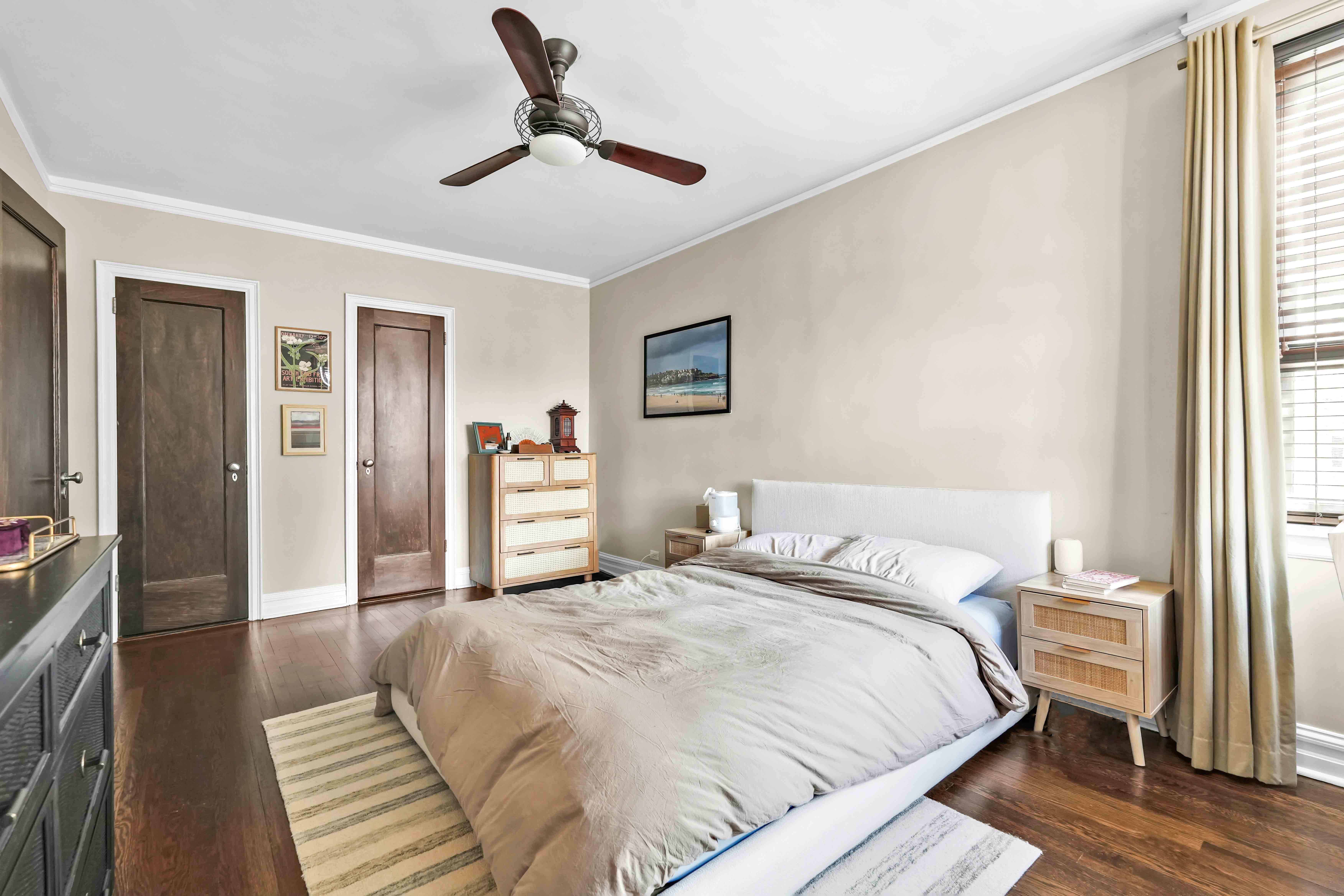 255 West 23rd Street, Unit 5GW Manhattan, NY 10011 - Photo 14 of 35 a bedroom with a large bed and a chandelier