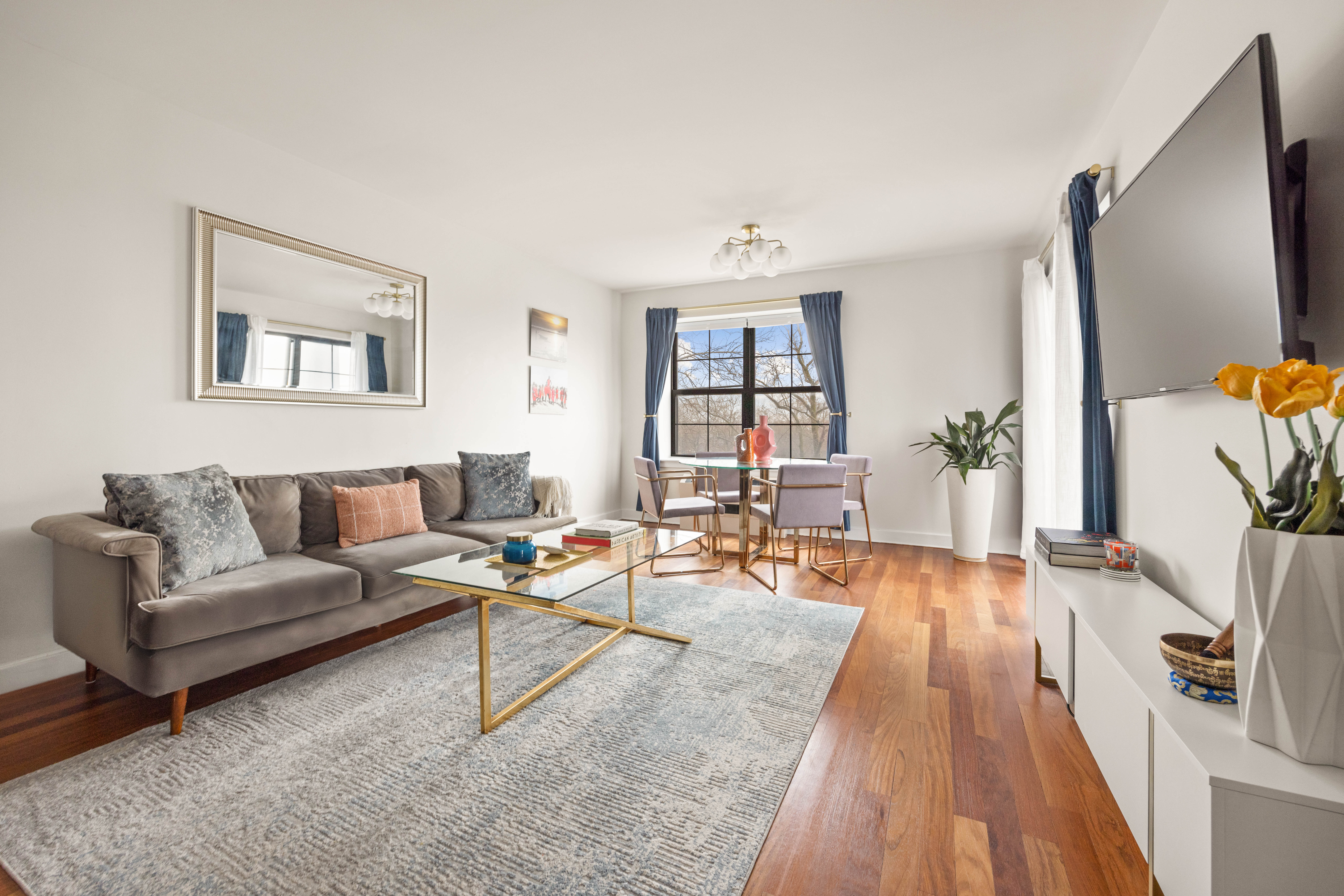 a living room with furniture and a wooden floor
