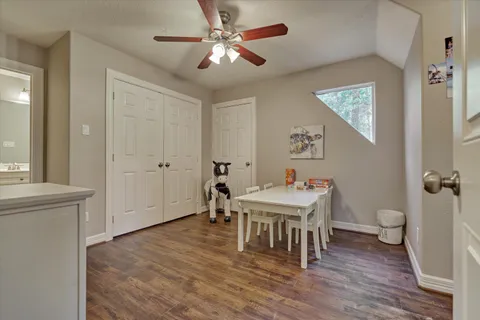 a room with a table chairs and wooden floor