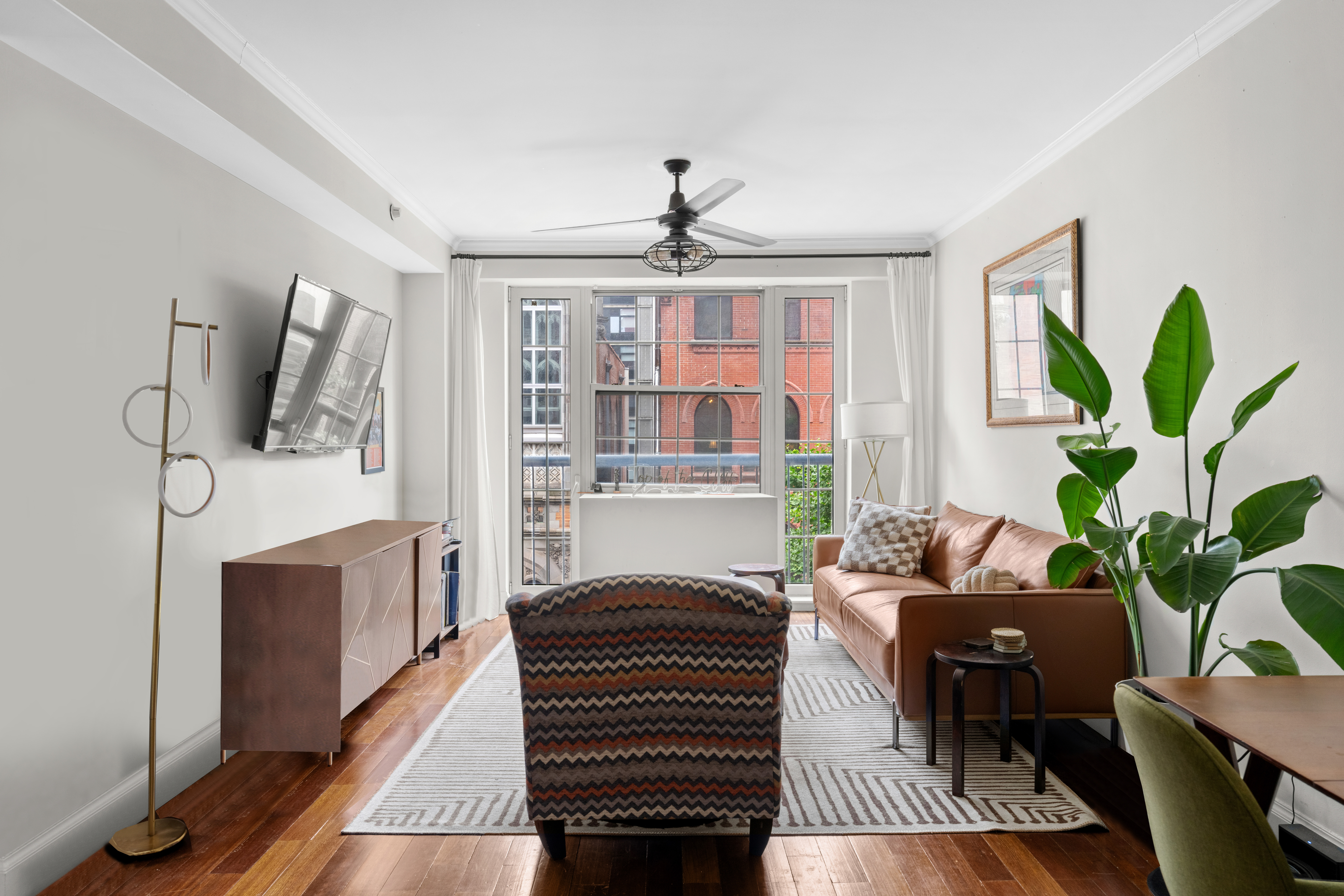 a living room with furniture a fireplace and a potted plant