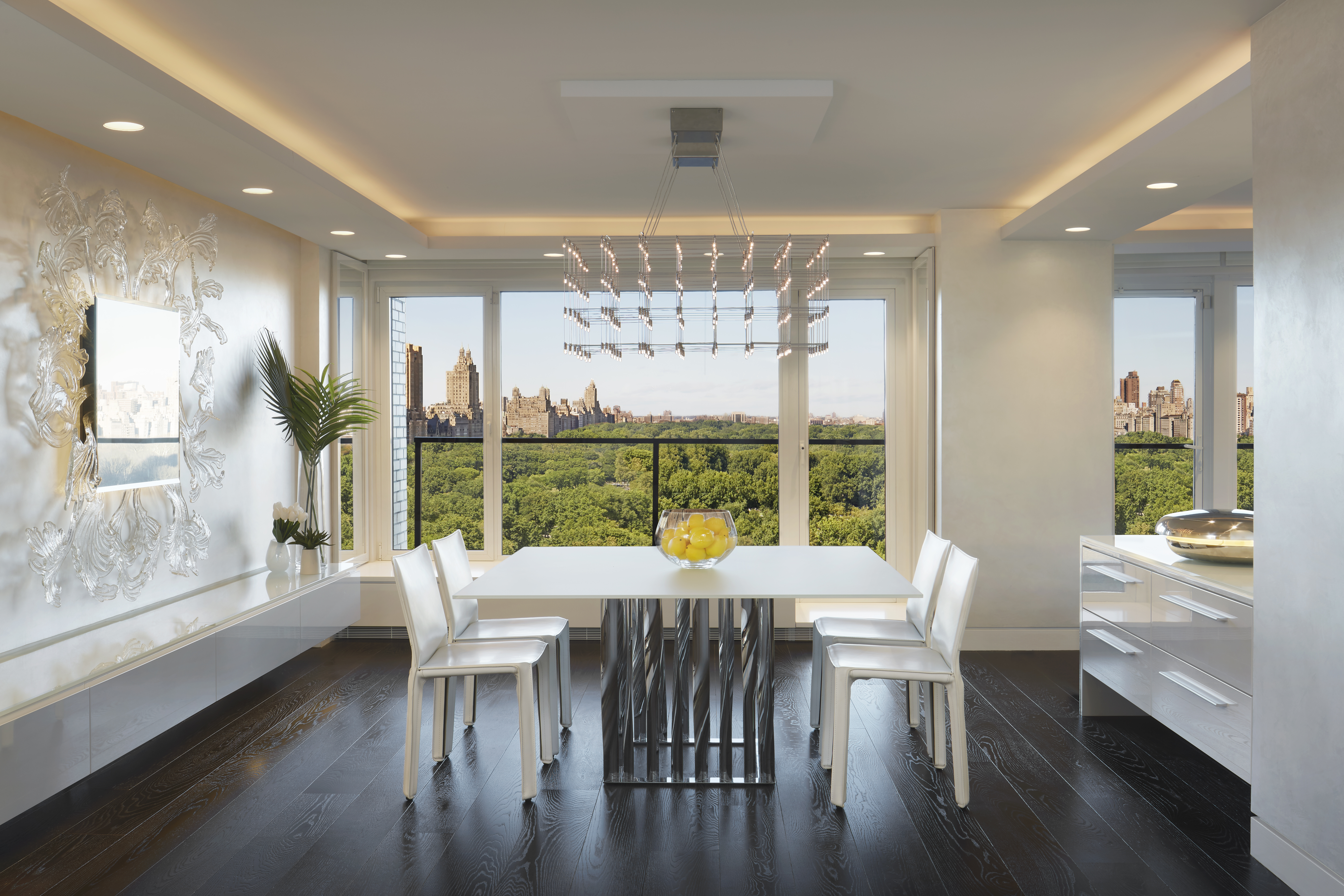 200 Central Park South, Unit 20DEF Manhattan, NY 10019 - Photo 7 of 16 a view of a dining room with furniture large window and wooden floor
