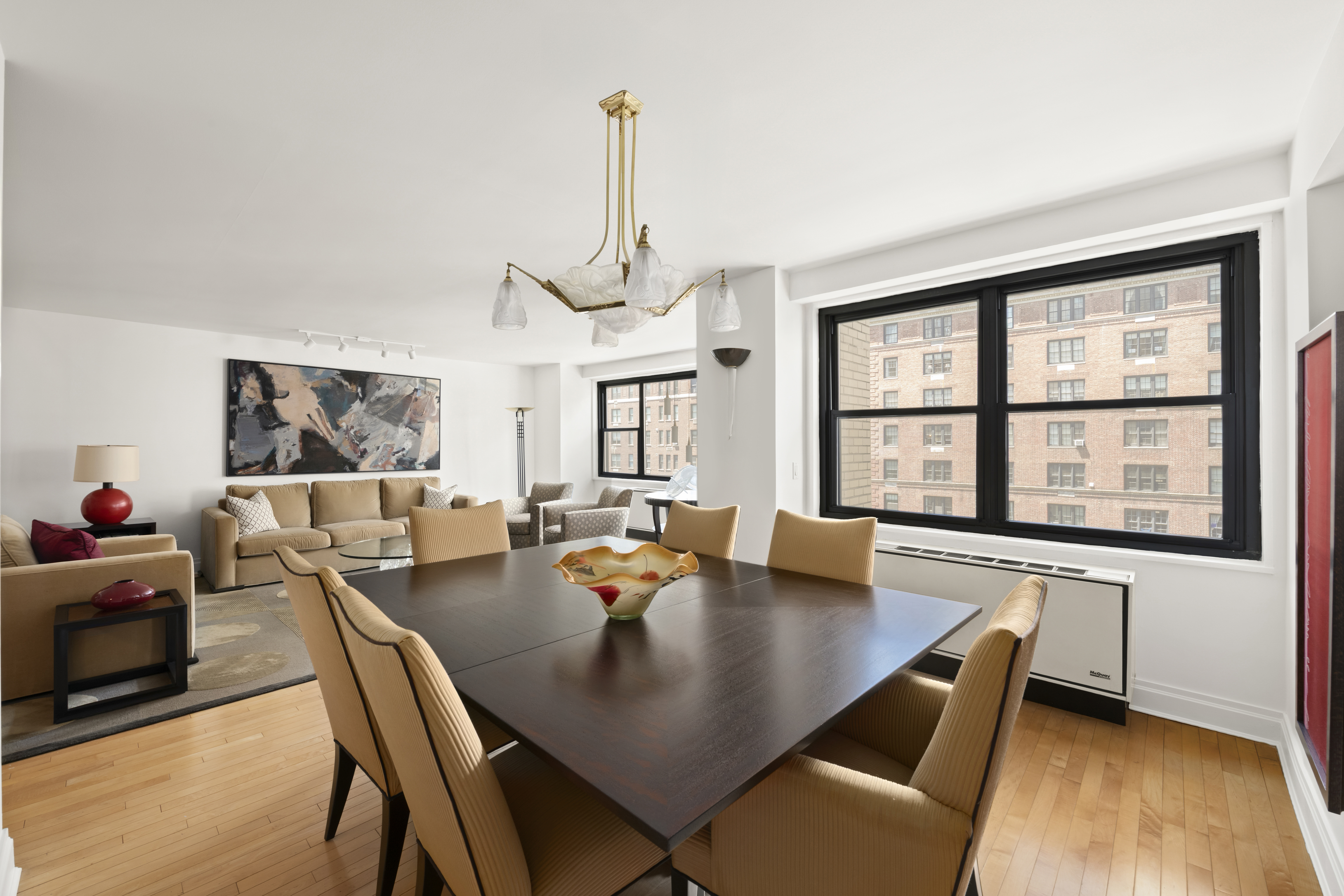 1065 Park Avenue, Unit 11A Manhattan, NY 10128 - Photo 3 of 14 a view of a dining room with furniture window and wooden floor
