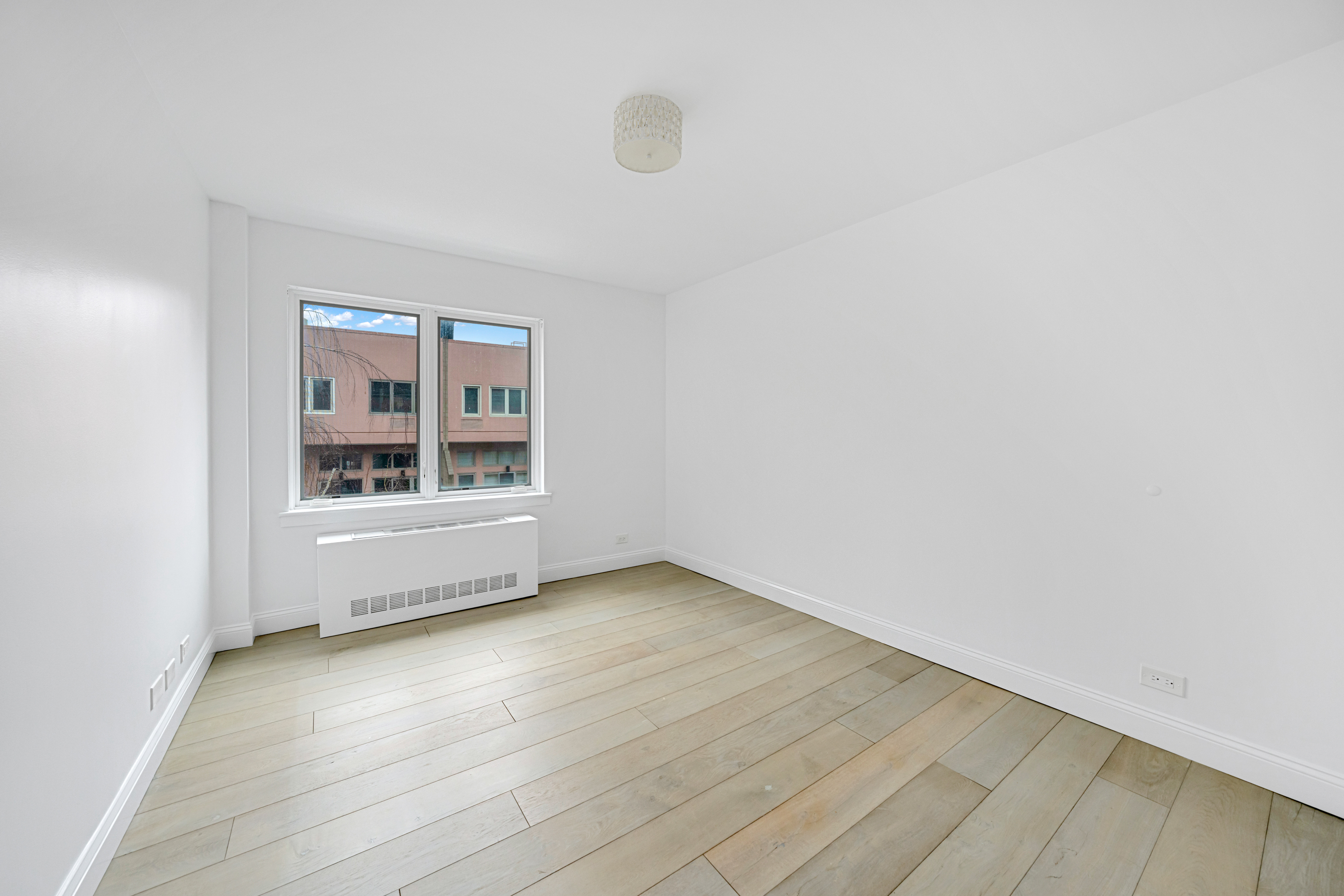 110 West 90th Street, Unit 5C Manhattan, NY 10024 - Photo 8 of 15 an empty room with wooden floor and windows