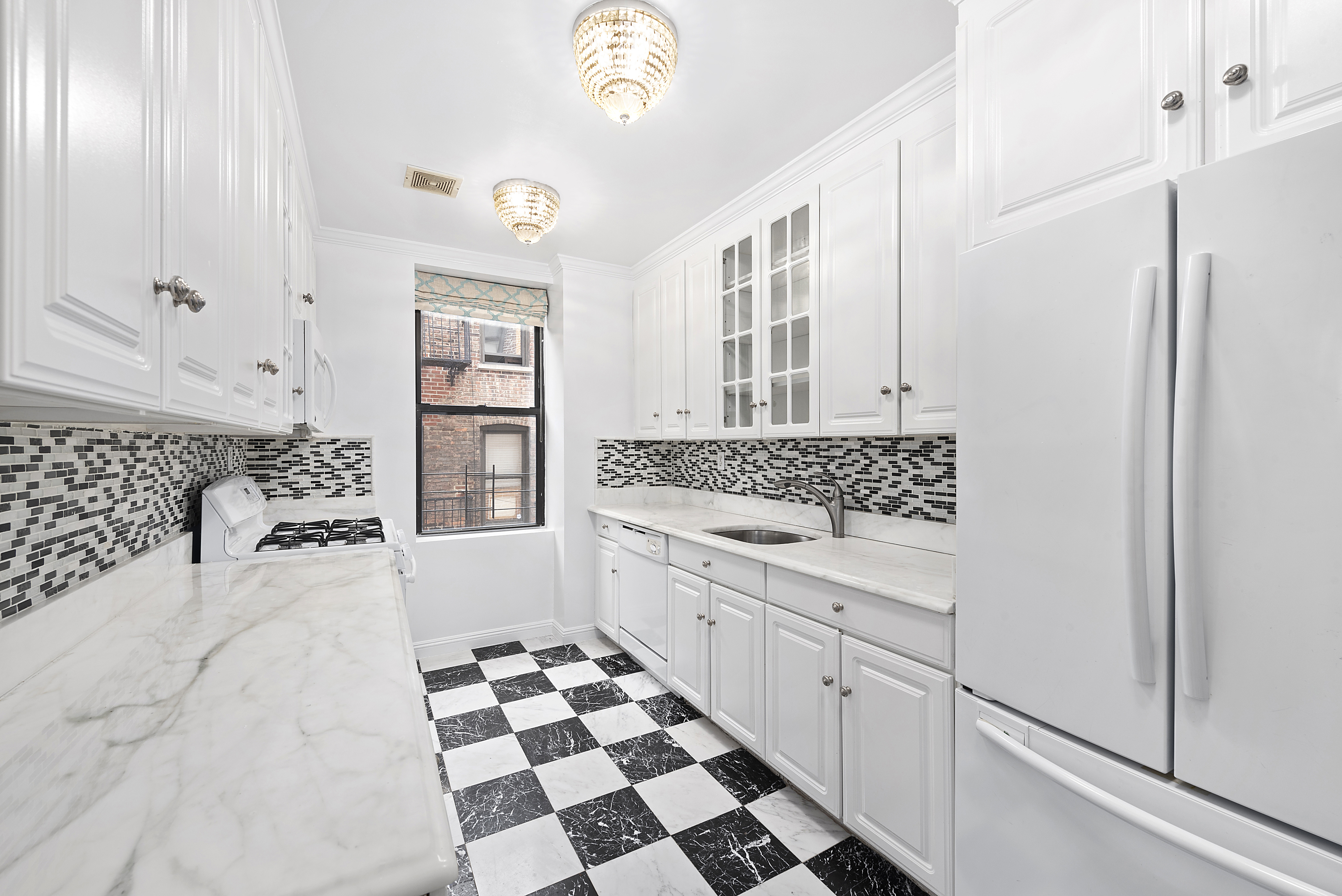 1240 Park Avenue, Unit 4D Manhattan, NY 10128 - Photo 2 of 9 a bathroom with a granite countertop sink and a mirror