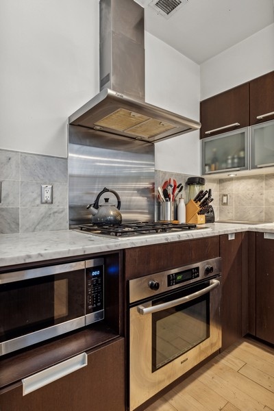119 Fulton Street, Unit 2B Manhattan, NY 10038 - Photo 2 of 10 a stove top oven sitting inside of a kitchen