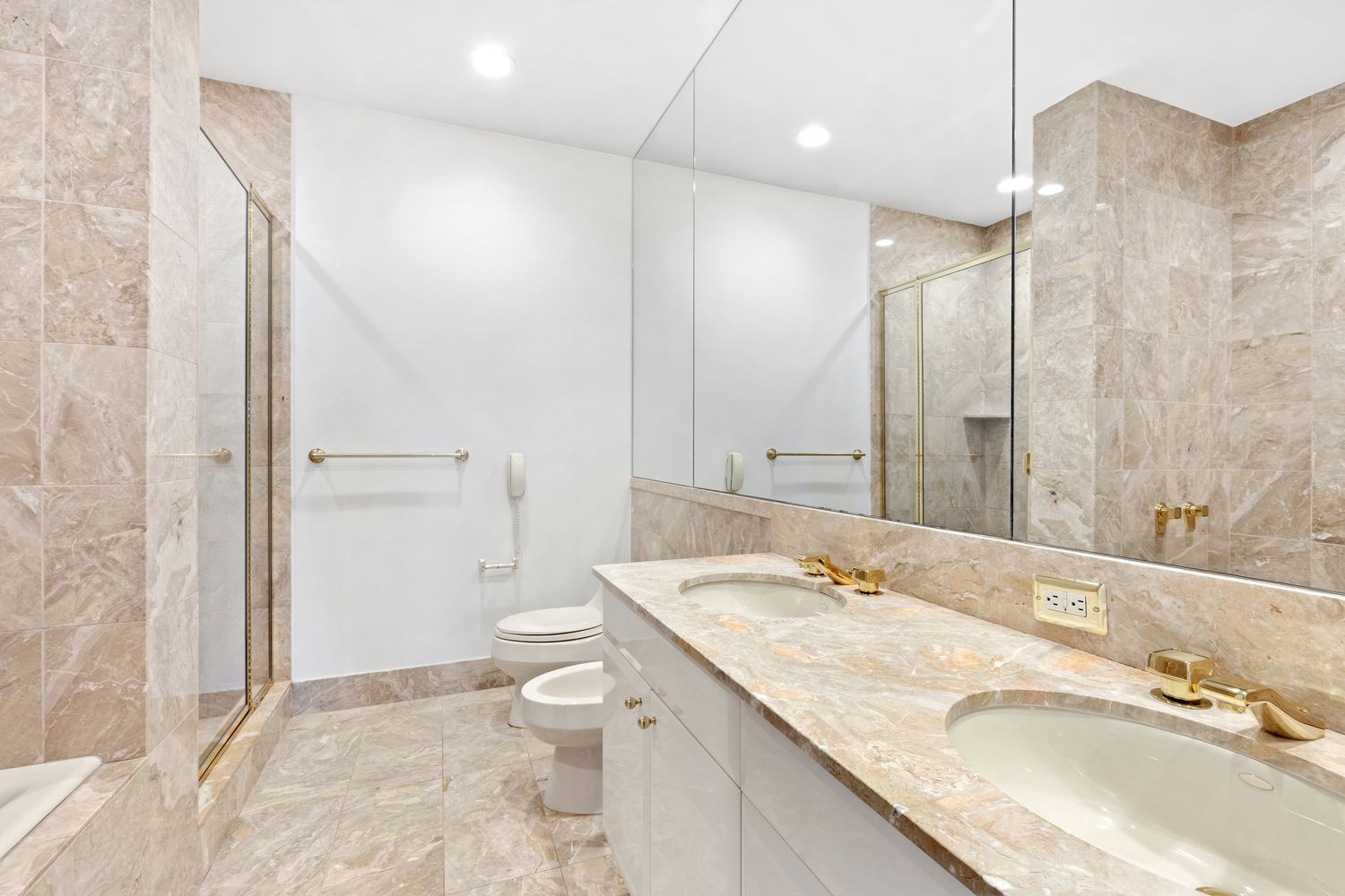 845 United Nations Plaza, Unit 63B Manhattan, NY 10017 - Photo 10 of 14 a bathroom with a granite countertop sink a toilet and shower