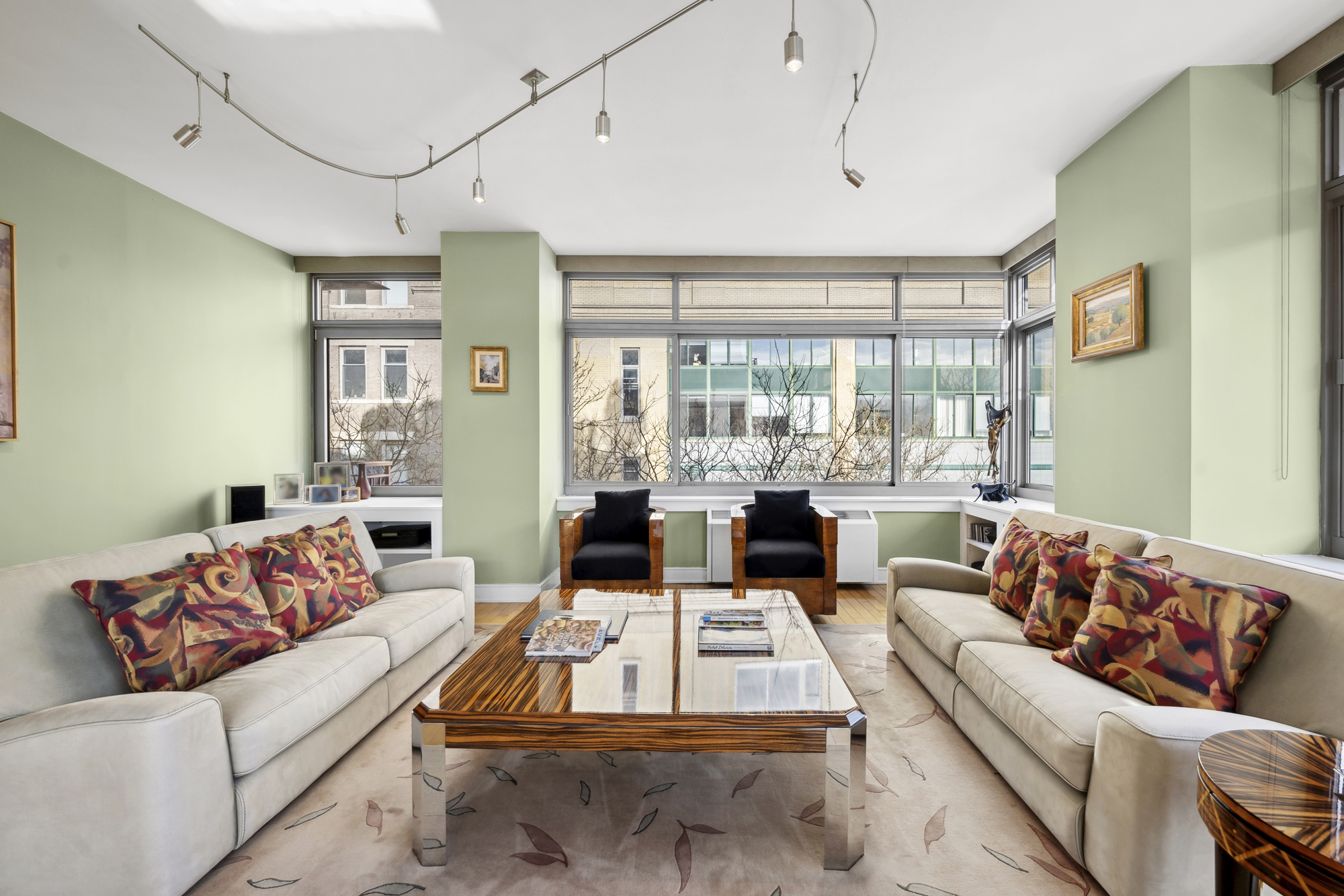 99 Jane Street, Unit 4H Manhattan, NY 10014 - Photo 3 of 22 a living room with furniture and a large window