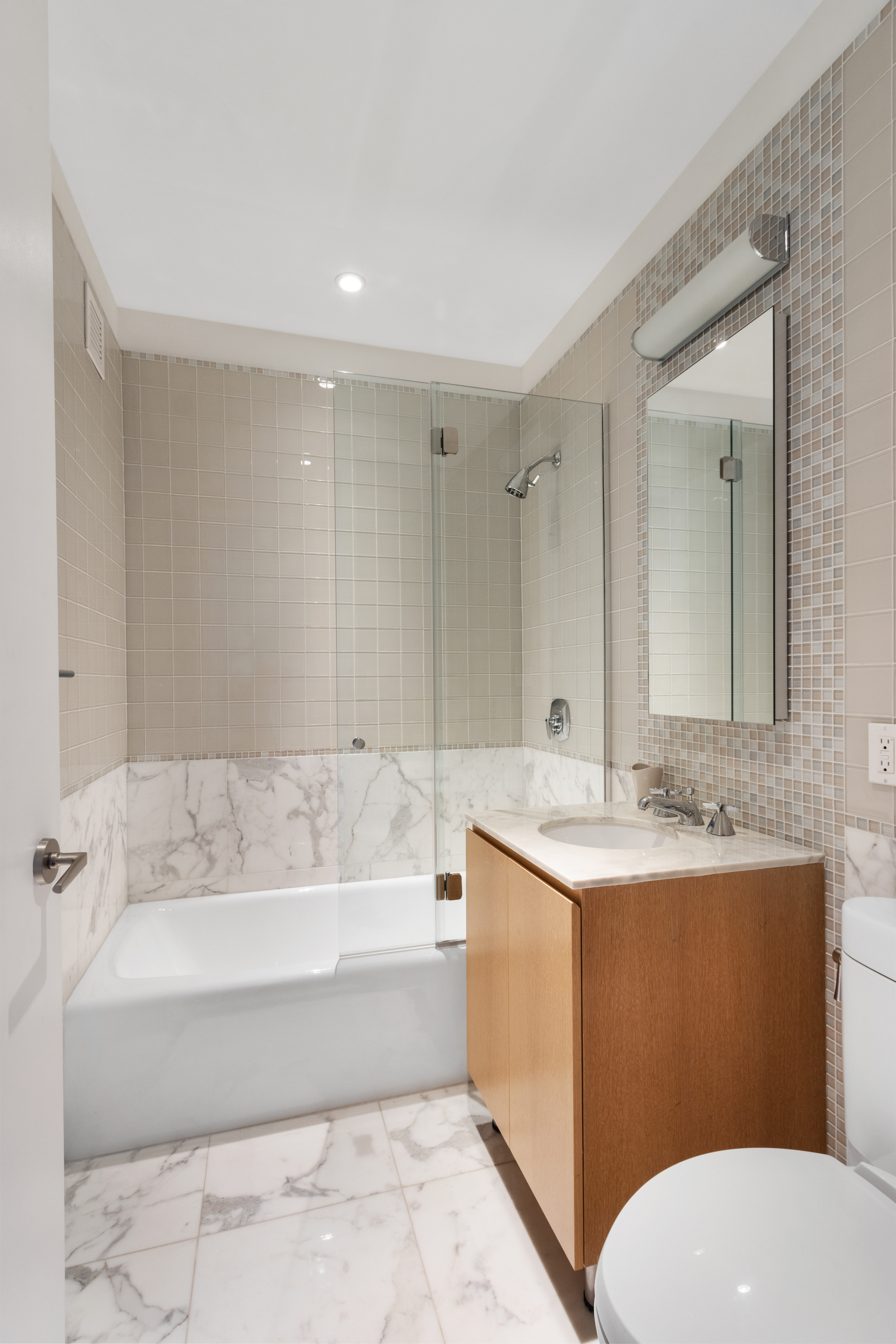 255 East 74th Street, Unit 25B Manhattan, NY 10021 - Photo 15 of 23 a bathroom with a sink a toilet and a bathtub