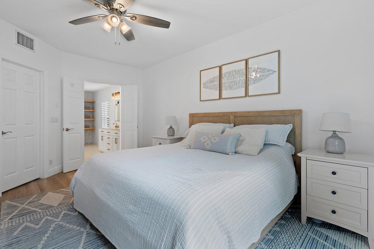 1182 Canoe Point Delray Beach, FL 33444 - Photo 14 of 46 a bedroom with a bed and a chandelier