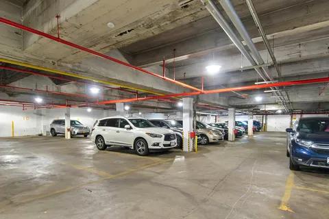 a view of parking garage with cars
