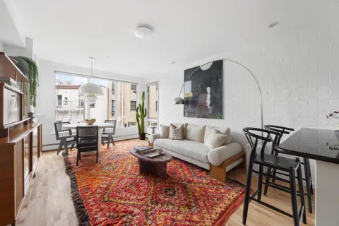 a living room with furniture and a rug