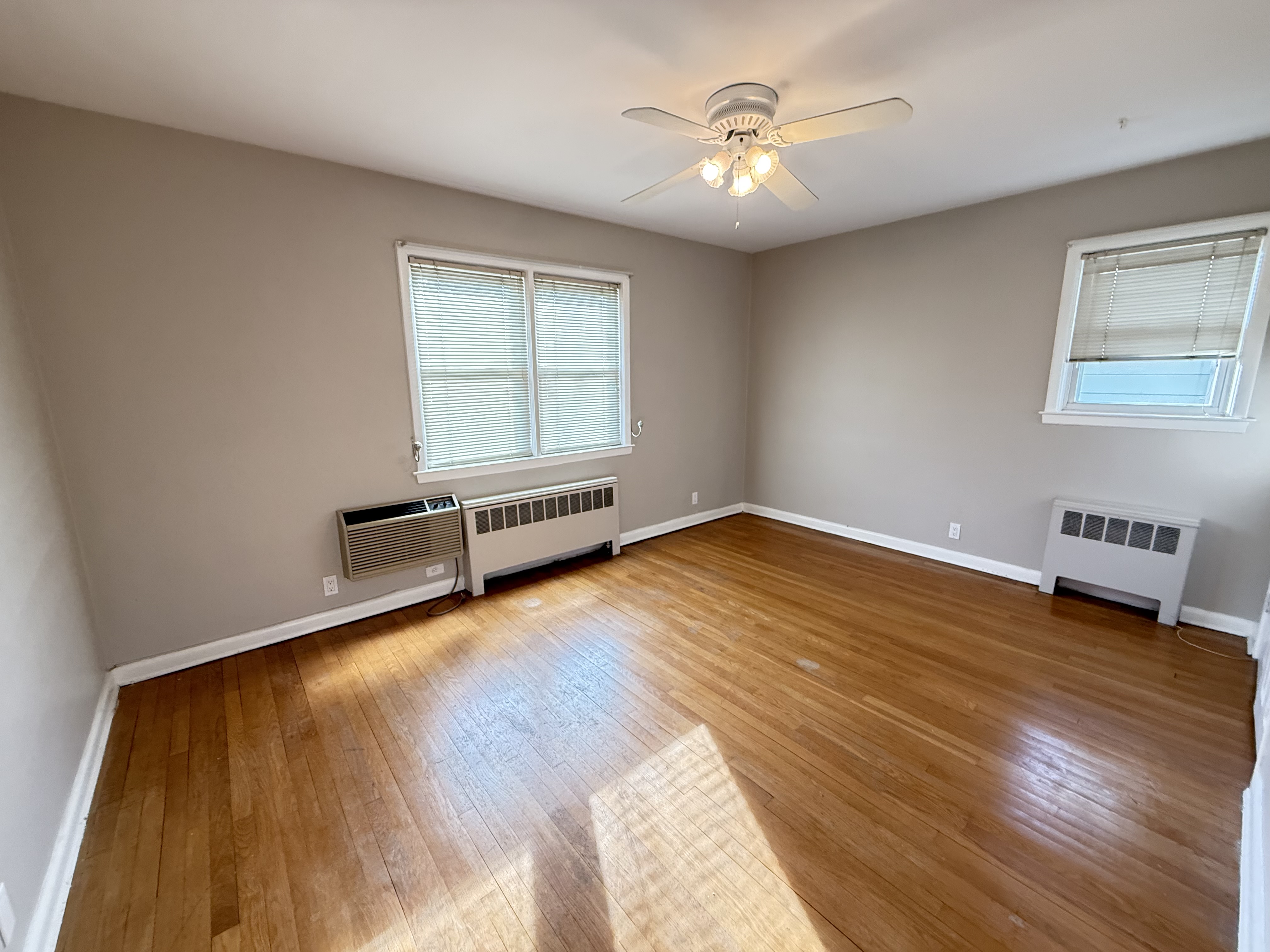 3236 Country Club Road Bronx, NY 10465 - Photo 12 of 22 a view of a room with wooden floor and ceiling fan