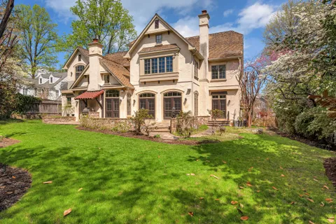 a front view of a house with yard and green space