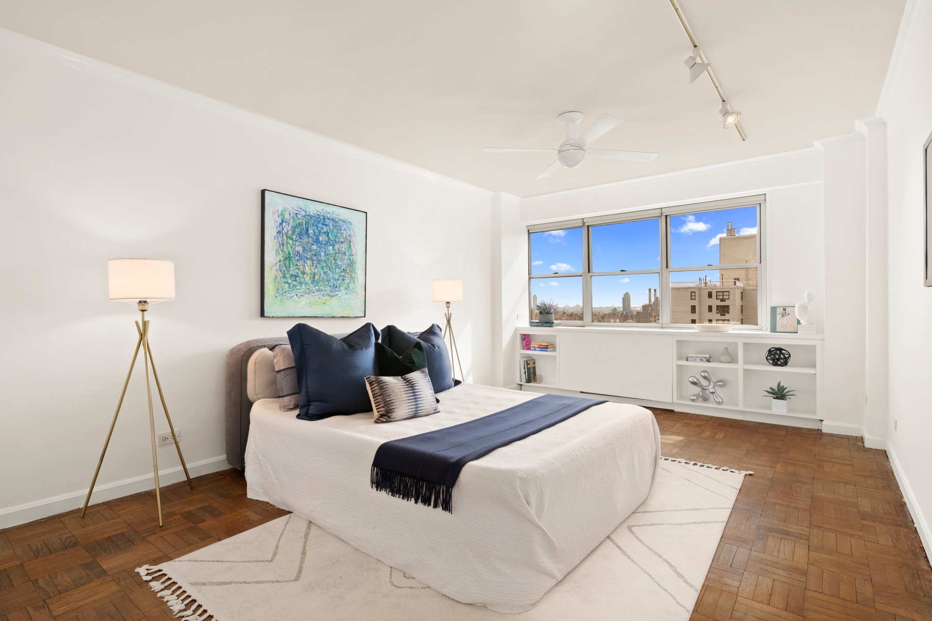 70 East 10th Street, Unit 20C Manhattan, NY 10003 - Photo 12 of 24 a bed room with a bed and a lamp