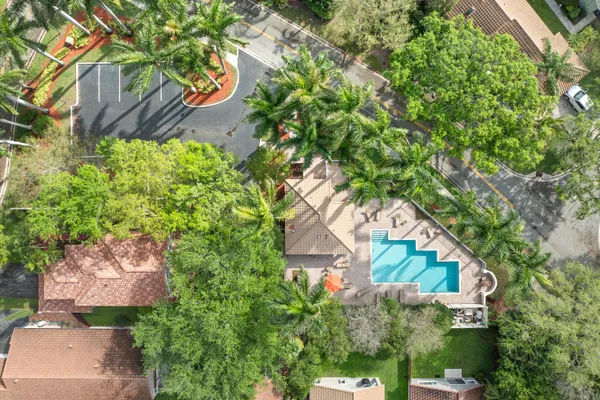 a view of a lake with a big yard and large trees