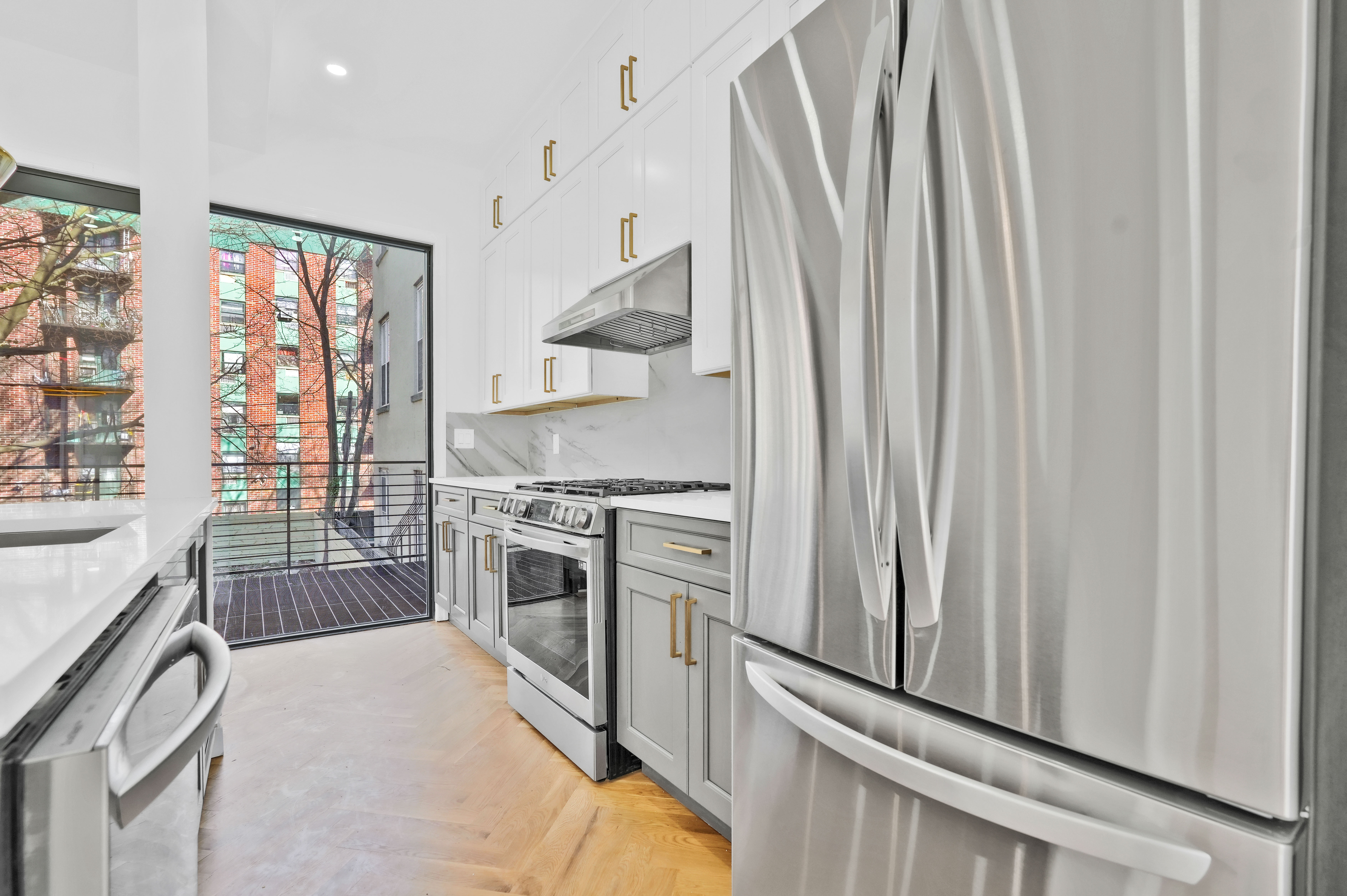 473 Monroe Street Brooklyn, NY 11221 - Photo 5 of 40 a kitchen with stainless steel appliances a stove and a refrigerator