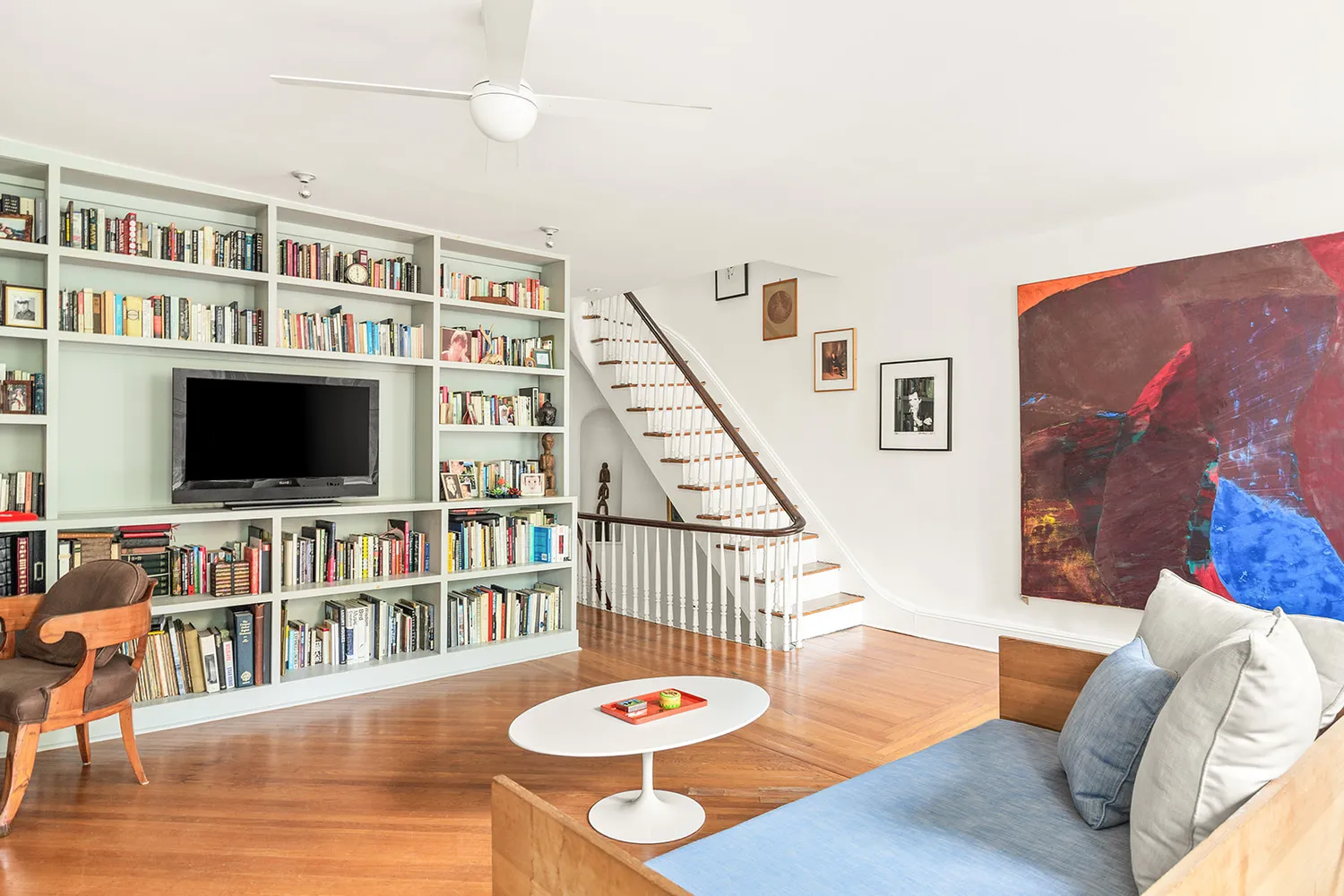 a living room with furniture and a flat screen tv