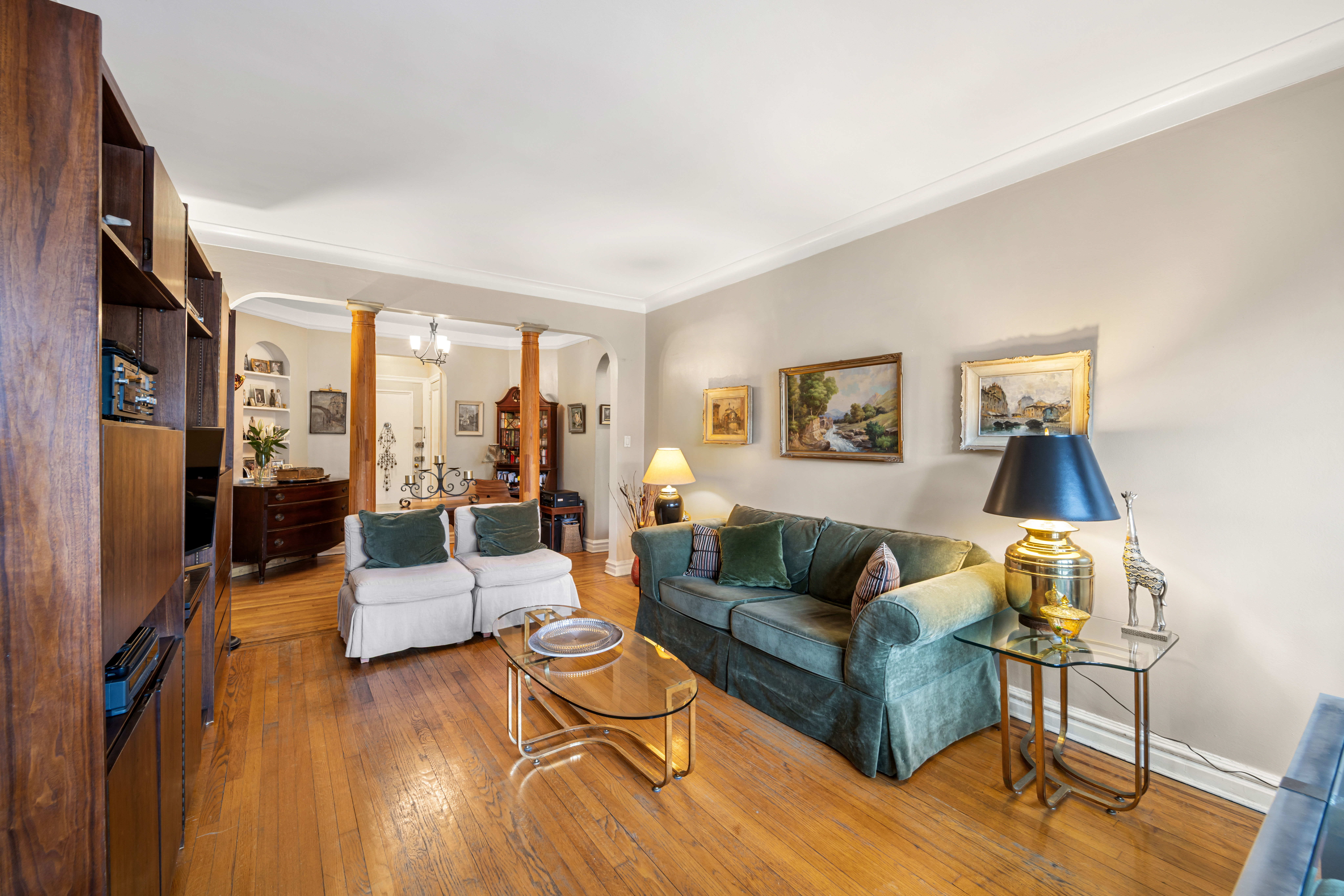 34-24 82nd Street, Unit 6N Queens, NY 11372 - Photo 2 of 15 a living room with furniture and a wooden floor