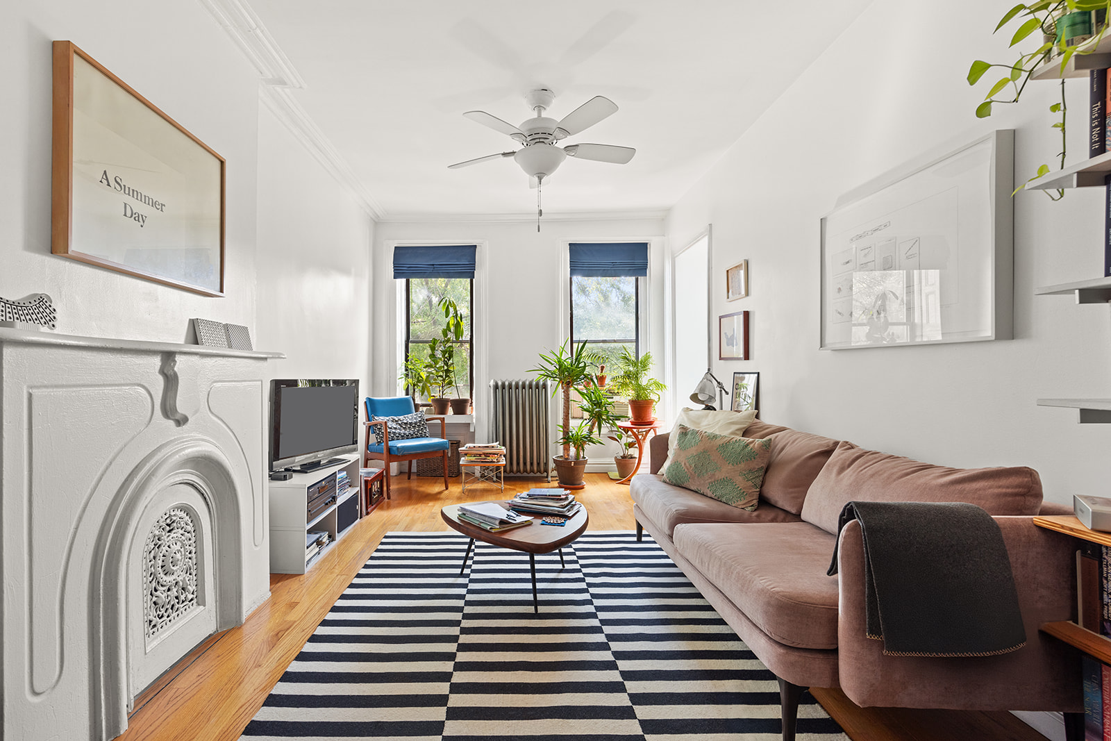 33 Park Place Brooklyn, NY 11217 - Photo 11 of 18 a living room with furniture a fireplace and a chandelier