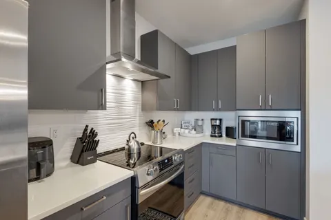 a kitchen with a sink stove and cabinets