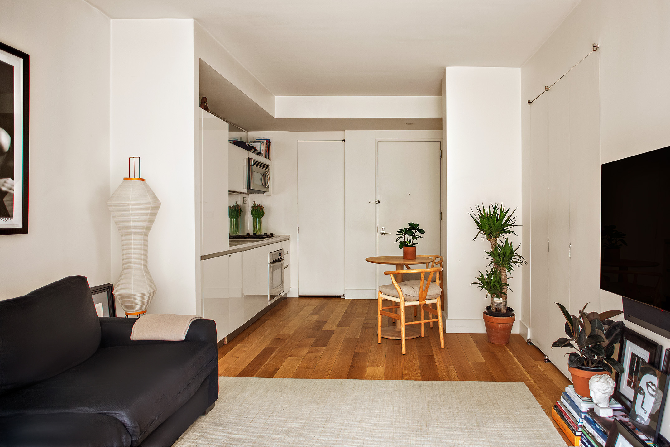 425 East 13th Street, Unit 3F Manhattan, NY 10009 - Photo 3 of 16 a living room with furniture and a flat screen tv