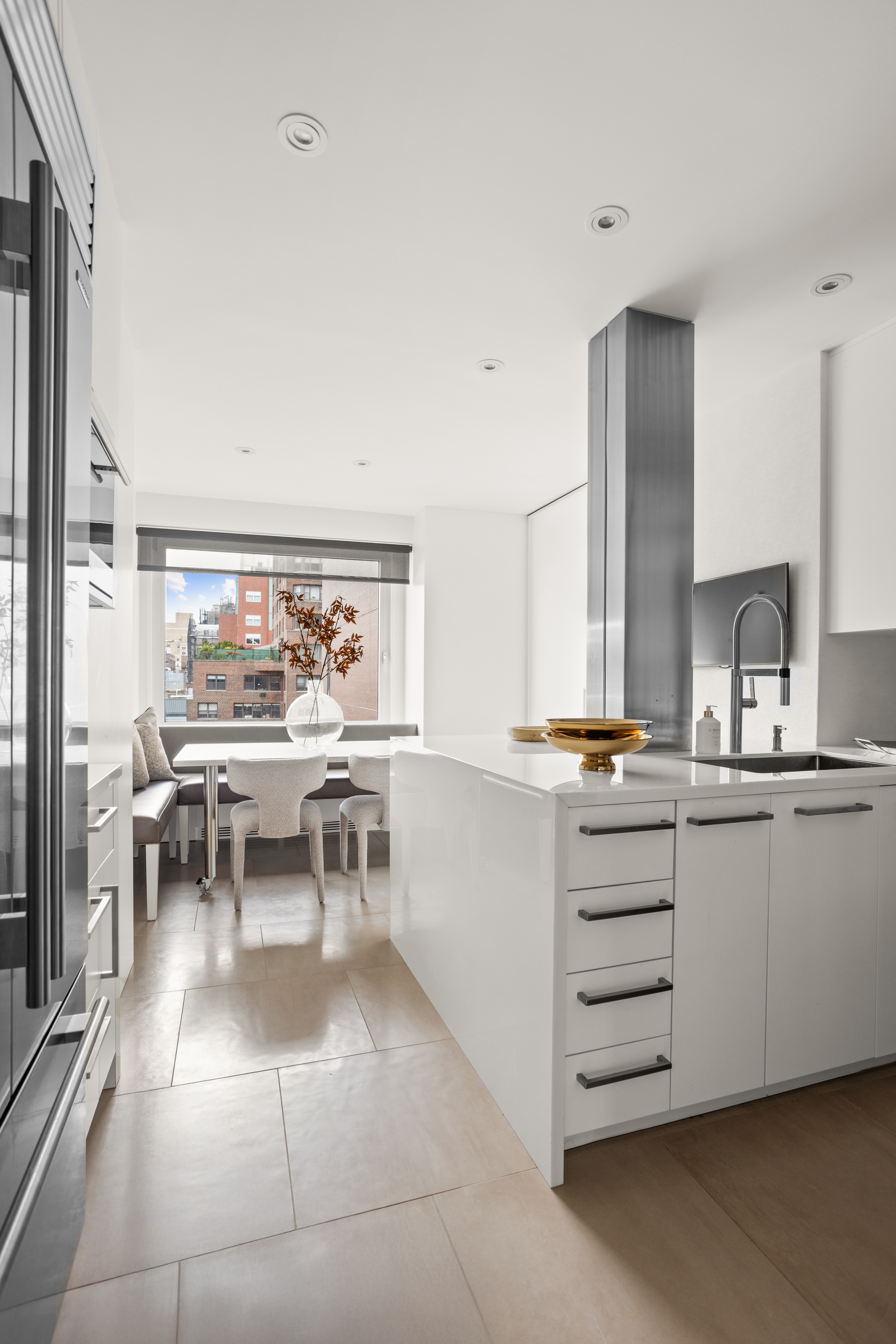 60 East End Avenue, Unit 12C Manhattan, NY 10028 - Photo 7 of 27 a kitchen with stainless steel appliances a sink and cabinets