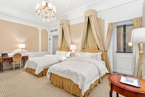 a bed room with two beds and a table