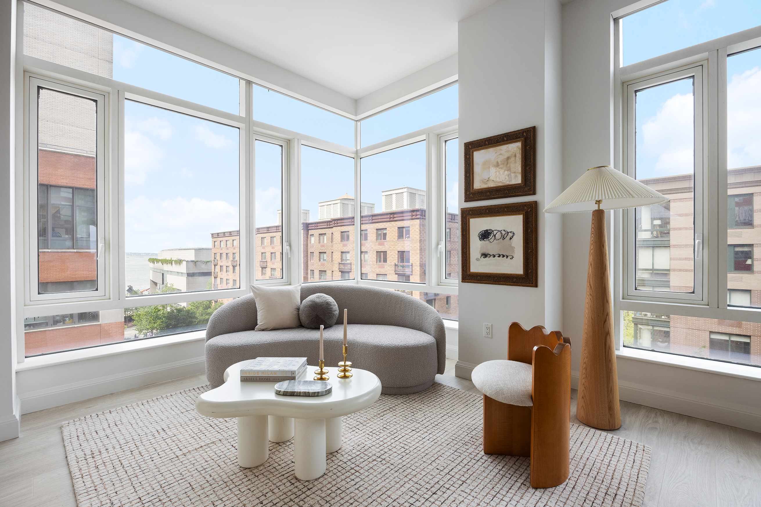 70 Little West Street, Unit 7L Manhattan, NY 10004 - Photo 7 of 25 a living room with furniture and a large window with wooden floor
