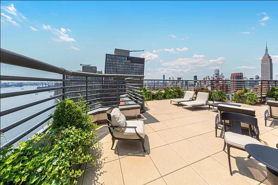 415 East 37th Street, Unit 32G Manhattan, NY 10016 - Photo 18 of 19 a view of a terrace with couches and a potted plant on a table