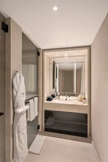 a bathroom with a double vanity sink and mirror
