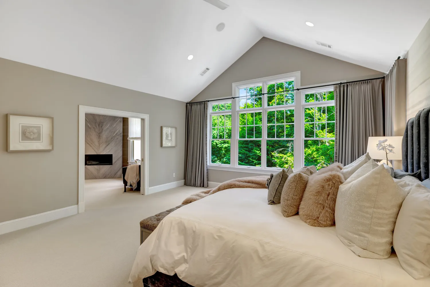 a spacious bedroom with a bed and a view of bedroom