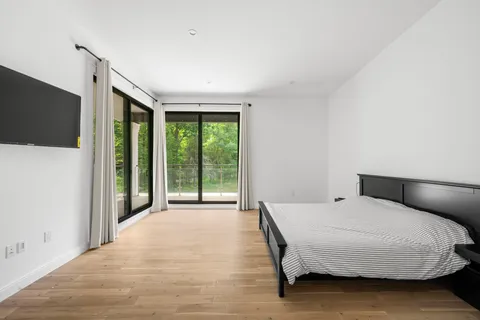a bedroom with a large bed and a large window