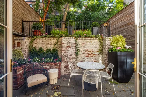 a view of a chairs and table in backyard
