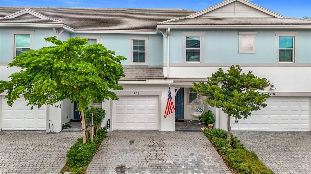 1821 Sandpiper Pointe Place Deerfield Beach, FL 33442 - Photo 1 of 1 a front view of a house with a yard and garage