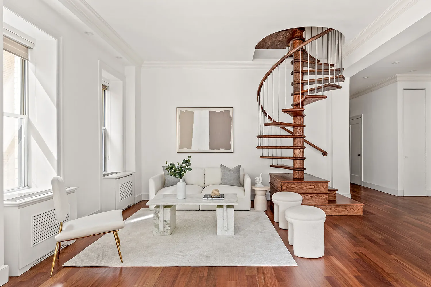a living room with furniture a table and wooden floor