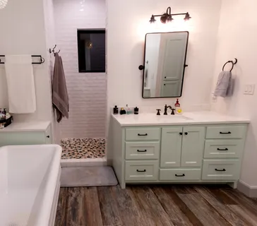 a bathroom with a double vanity sink mirror and