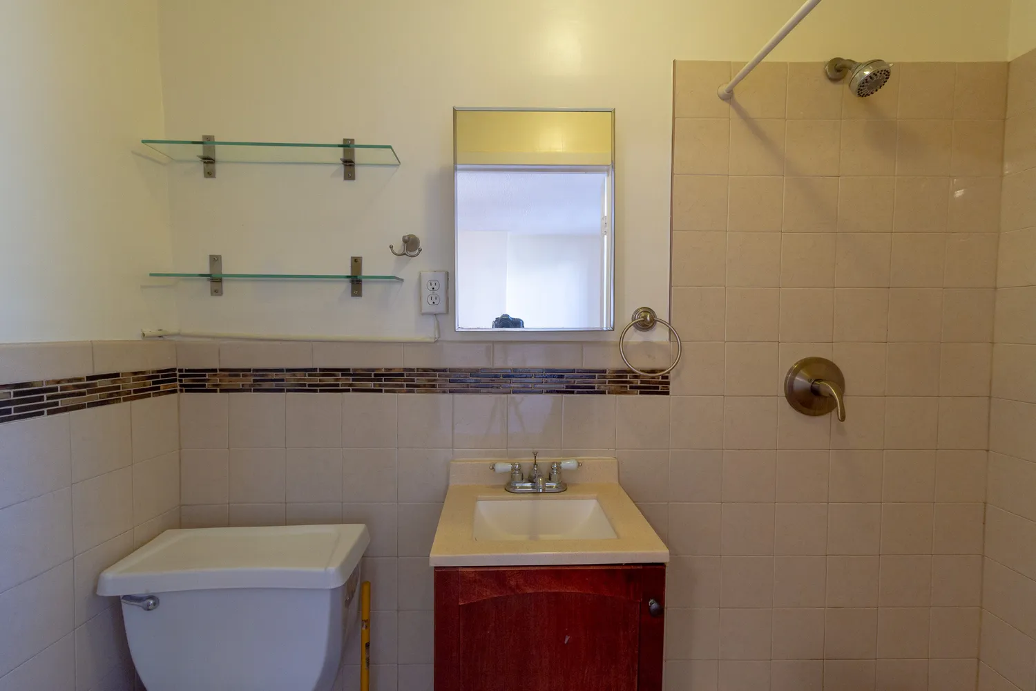 a bathroom with a sink a toilet and shower