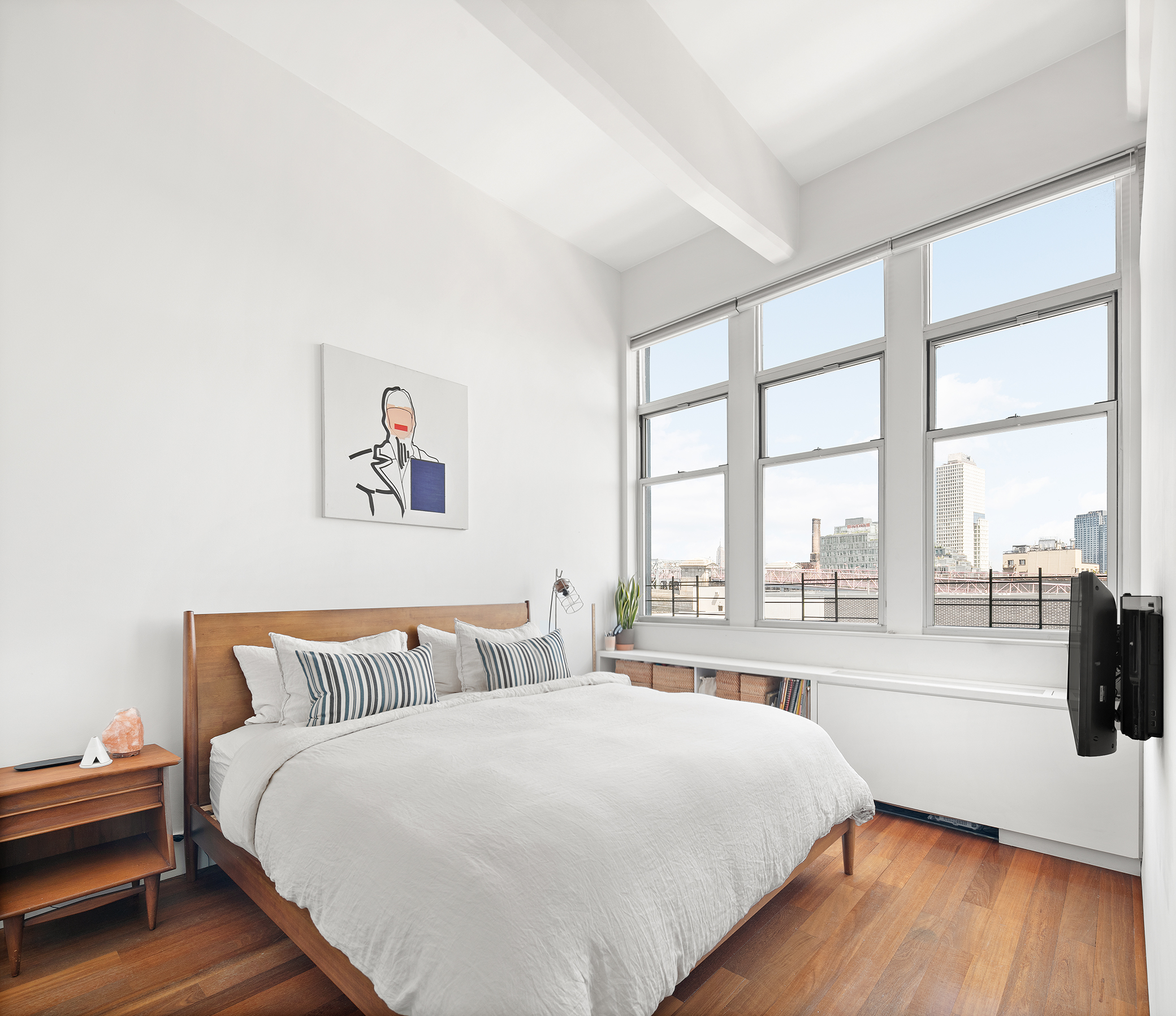 60 Broadway, Unit 6H Brooklyn, NY 11249 - Photo 6 of 16 a bedroom with a bed and a large window with outer view
