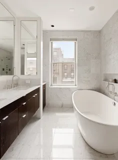 a living room with furniture a fireplace and a large window