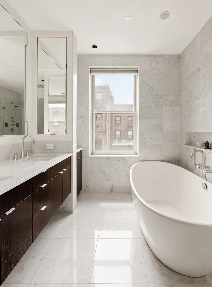 a living room with furniture a fireplace and a large window