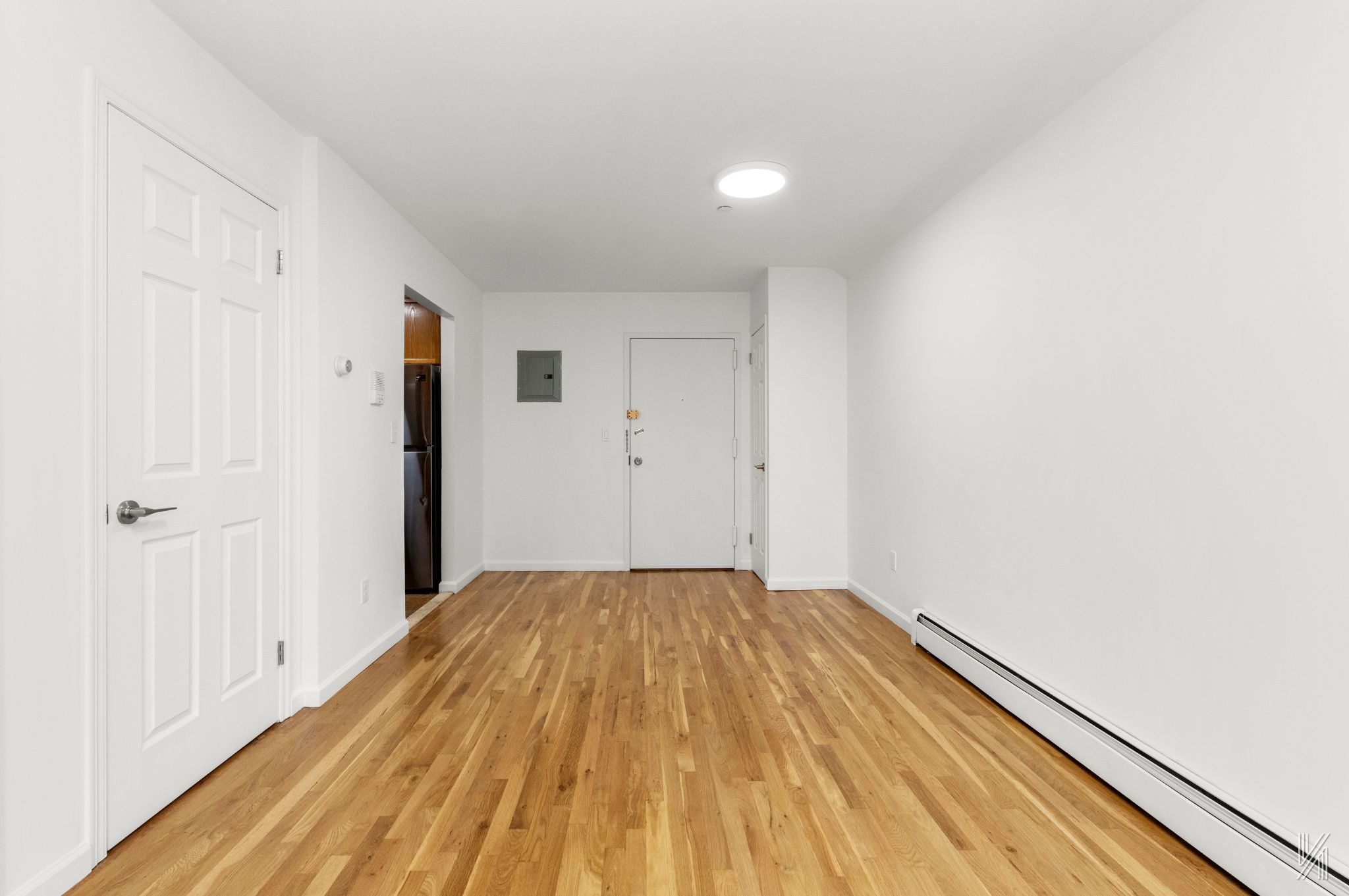 41-36 66th Street, Unit 2B Queens, NY 11377 - Photo 6 of 19 a view of a room with wooden floor and a hallway