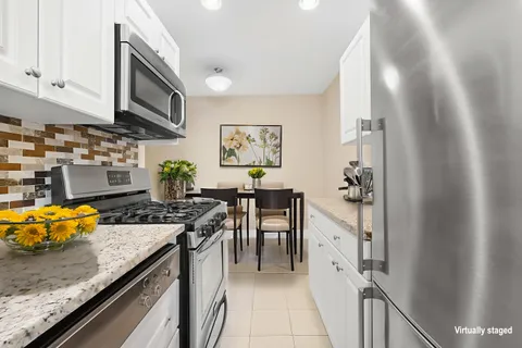 a kitchen with stainless steel appliances granite countertop a stove and a sink