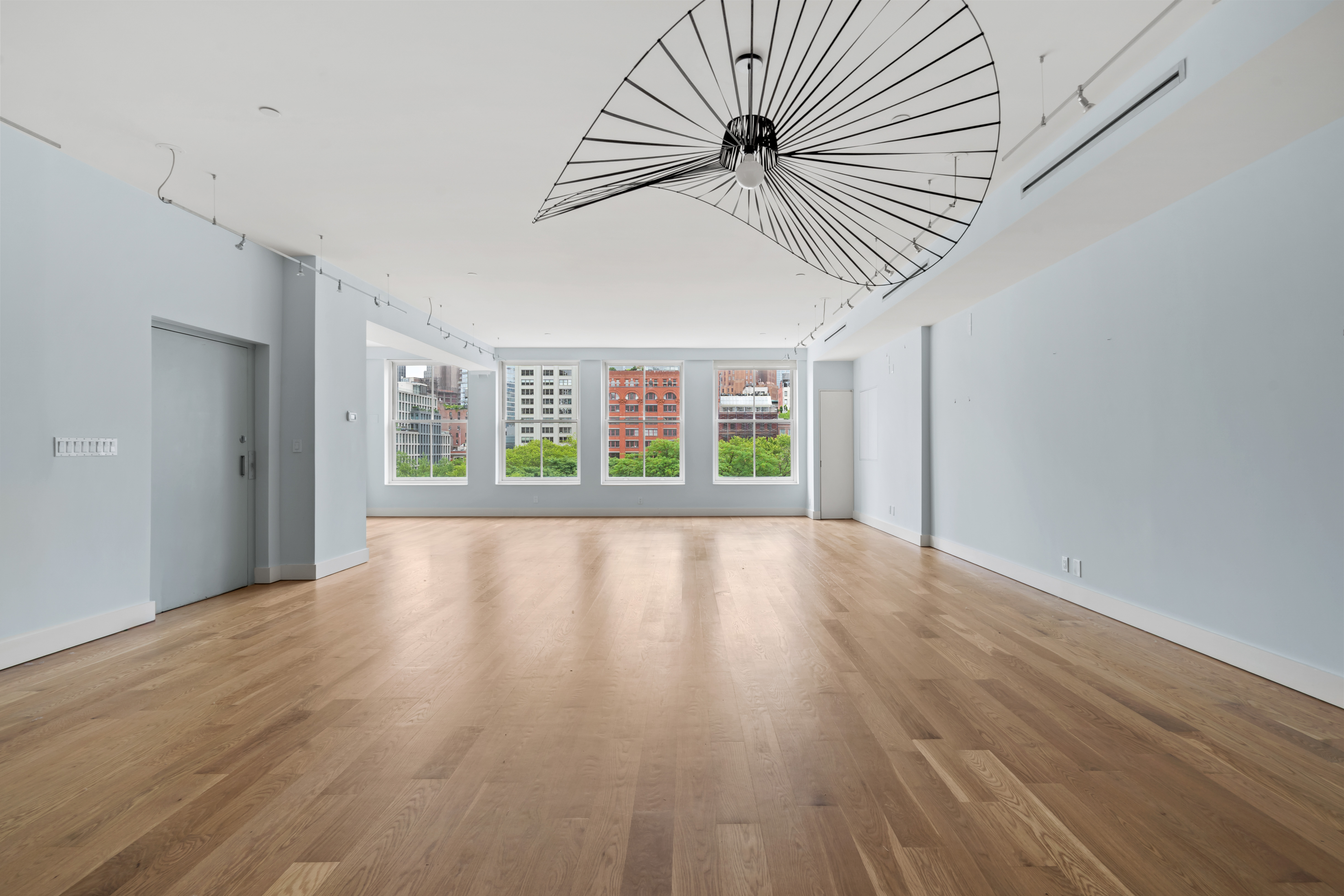 32 Laight Street, Unit 5 Manhattan, NY 10013 - Photo 10 of 31 a view of an empty room with wooden floor and a window
