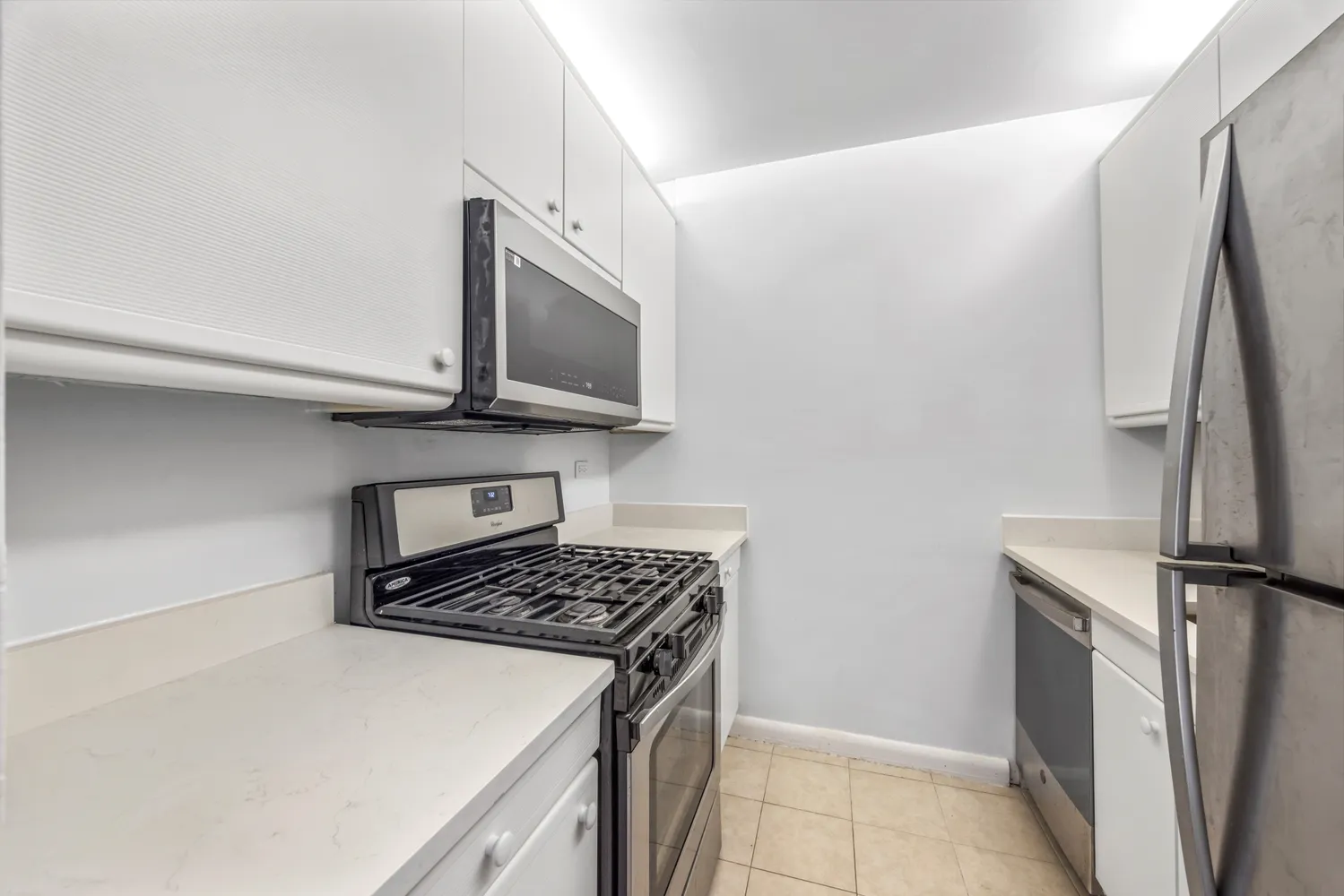 a kitchen with a refrigerator stove and microwave