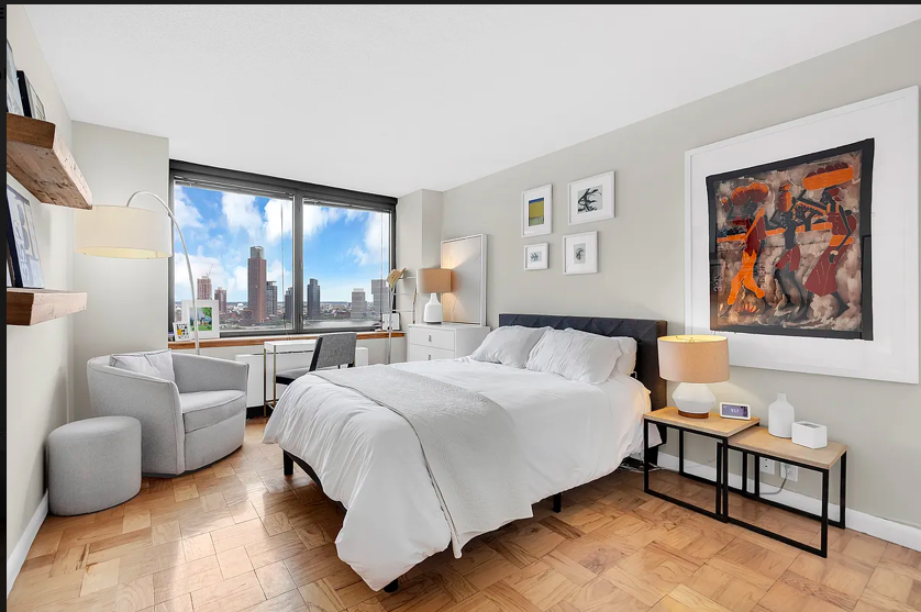 415 East 37th Street, Unit 22B Manhattan, NY 10016 - Photo 3 of 6 a spacious bedroom with a bed and a large window